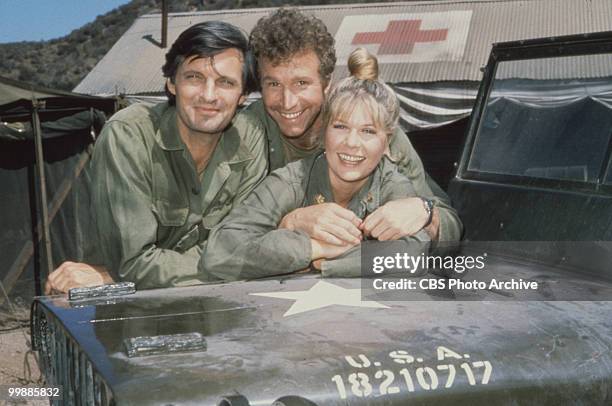 Portrait of, from left, American actors Alan Alda, as Captain Benjamin Hawkeye Pierce, Wayne Rogers, as Captain Trapper John McIntyre, and Loretta...