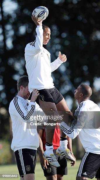 Dennis Aogo of Germany is lifted in the air by his team mates Jerome Boateng and Per Mertesacker during a German National Team rugby training session...