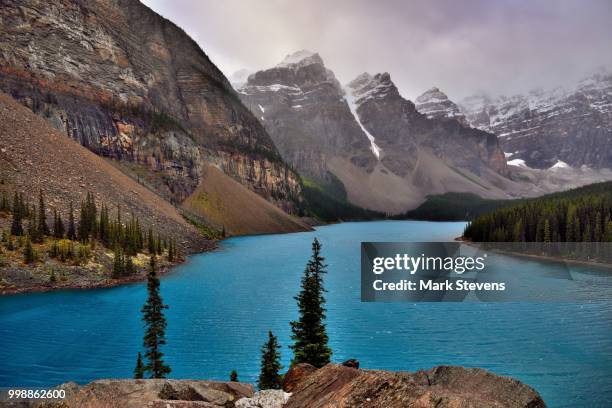 from atop the rockpile and a view across moraine lake and the valley of the ten peaks - valley of the ten peaks stock pictures, royalty-free photos & images