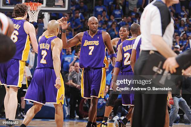 Lamar Odom of the Los Angeles Lakers high fives Derek Fisher during the game against the Oklahoma City Thunder in Game Six of the Western Conference...