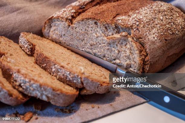 fresh bread cut by knife - bread knife stock pictures, royalty-free photos & images