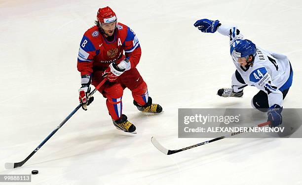 Russia's Alexander Ovechkin of NHL's Washington Capitals views with Finland's Sami Vatanen during a qualification round match of the IIHF...