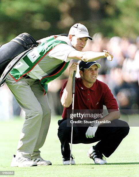 Sergio Garcia of Spain consults his caddie on the 17th fairway during the third round of the Lancome Trophy at the St-Nom-la-Breteche Golf Club,...