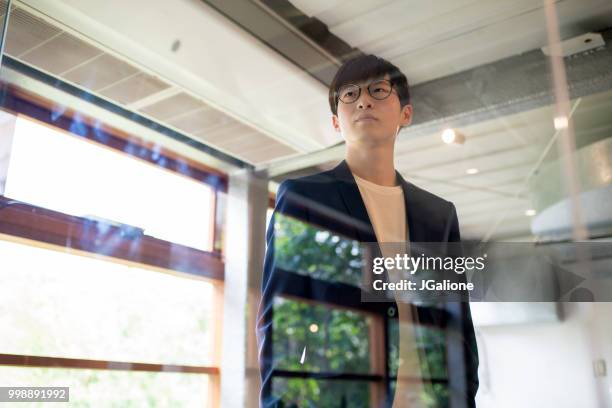 portrait of a confident young businessman - jgalione stock pictures, royalty-free photos & images