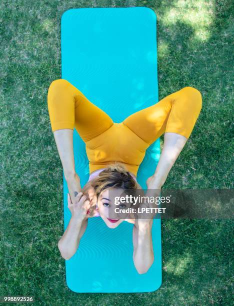 yoga at the park - contortionist stock pictures, royalty-free photos & images