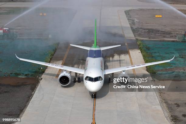 The No.102 C919 passenger jet lands at Dongying Shengli Airport on July 12, 2018 in Dongying, Shandong Province of China. Flying from the final...
