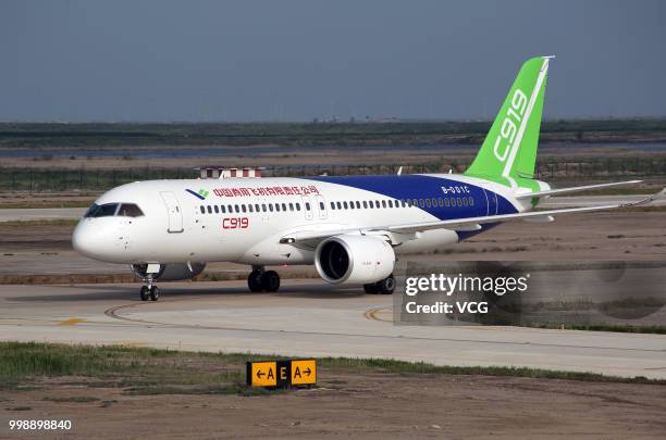 The No.102 C919 passenger jet lands at Dongying Shengli Airport on July 12, 2018 in Dongying, Shandong Province of China. Flying from the final...