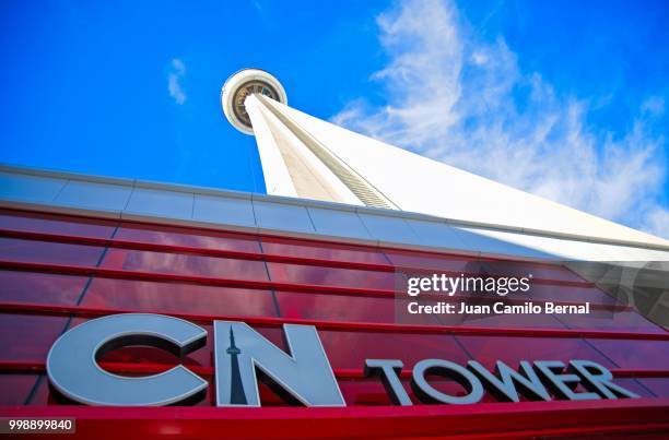 view of the iconic cn tower in downtown toronto, canada, during a sunny day - canada tower stock pictures, royalty-free photos & images