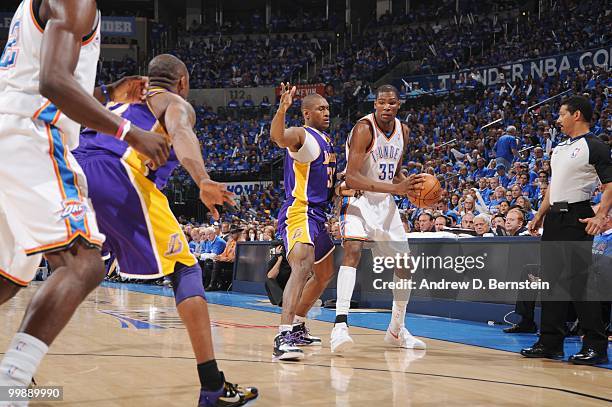 Kevin Durant of the Oklahoma City Thunder holds the ball against Ron Artest of the Los Angeles Lakers in Game Six of the Western Conference...