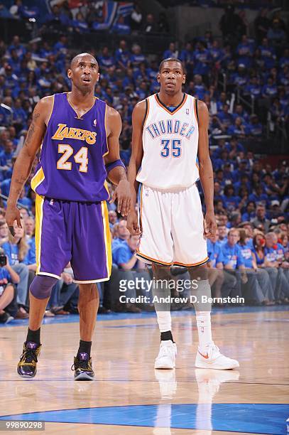 Kobe Bryant of the Los Angeles Lakers and Kevin Durant of the Oklahoma City Thunder follow the action in Game Six of the Western Conference...