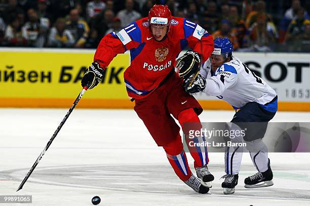 Evgeni Malkin of Russia is challenged by Sami Kapanen of Finland during the IIHF World Championship qualification round match between Russia and...