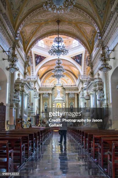 man walking inside the guanajuato basilica. - guanajuato state stock pictures, royalty-free photos & images