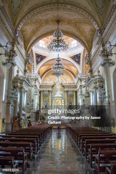 man walking inside the guanajuato basilica. - guanajuato state stock pictures, royalty-free photos & images