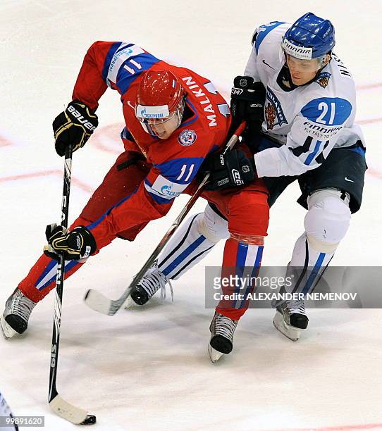 Russia's Evgeni Malkin of NHL's Pittsburgh Penguins views with Finland's Janne Niskala during a qualification round match of the IIHF International...
