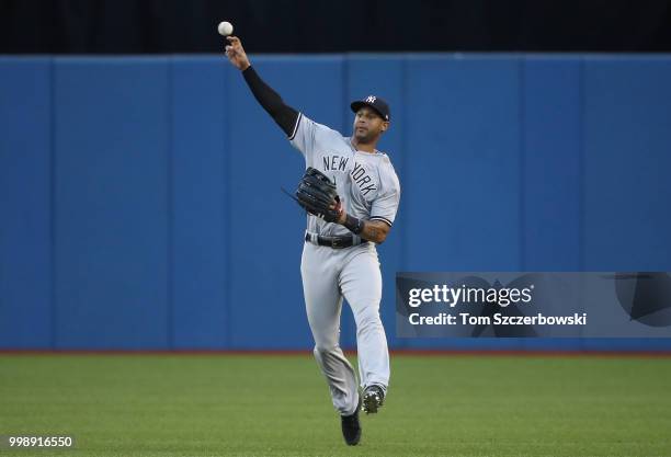 Aaron Hicks of the New York Yankees throws the ball back to the infield during MLB game action against the Toronto Blue Jays at Rogers Centre on July...