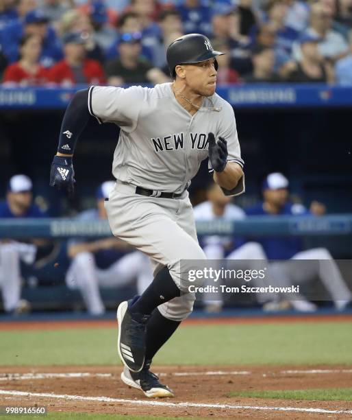 Aaron Judge of the New York Yankees legs out an infield single in the fifth inning during MLB game action against the Toronto Blue Jays at Rogers...