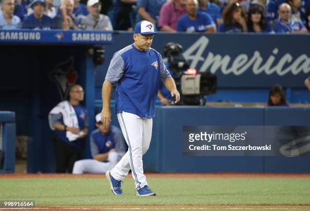 Manager John Gibbons of the Toronto Blue Jays comes out of the dugout to make a pitching change in the fifth inning during MLB game action against...