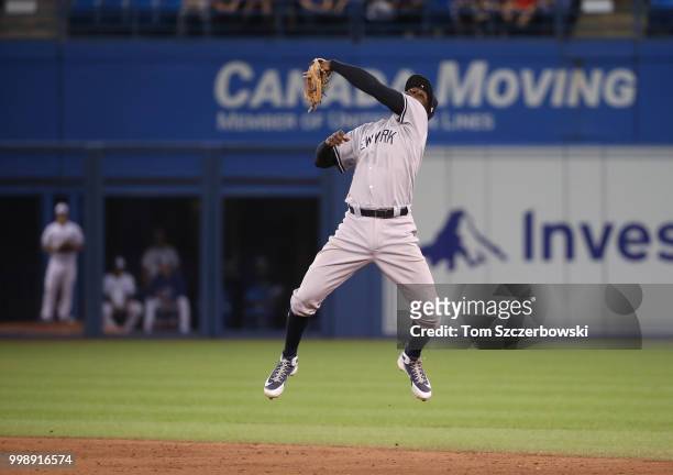 Didi Gregorius of the New York Yankees leaps but cannot snare a line drive single hit over his head by Yangervis Solarte of the Toronto Blue Jays in...