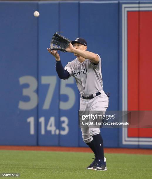 Aaron Judge of the New York Yankees catches a fly ball in the sixth inning during MLB game action against the Toronto Blue Jays at Rogers Centre on...