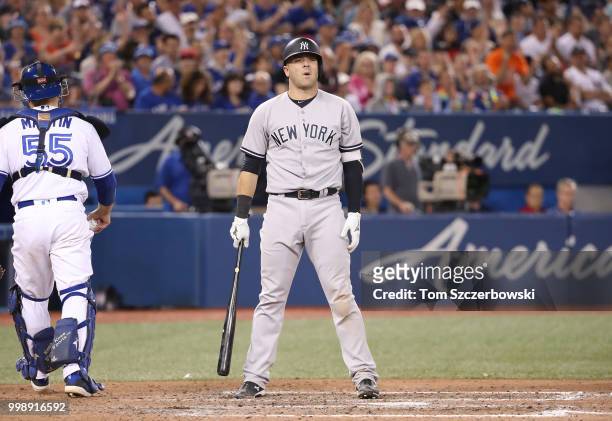 Austin Romine of the New York Yankees reacts after being called out on strikes in the eighth inning during MLB game action against the Toronto Blue...