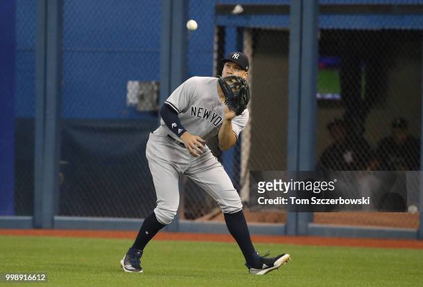 Aaron Judge of the New York Yankees catches a fly ball in the fifth inning during MLB game action against the Toronto Blue Jays at Rogers Centre on...