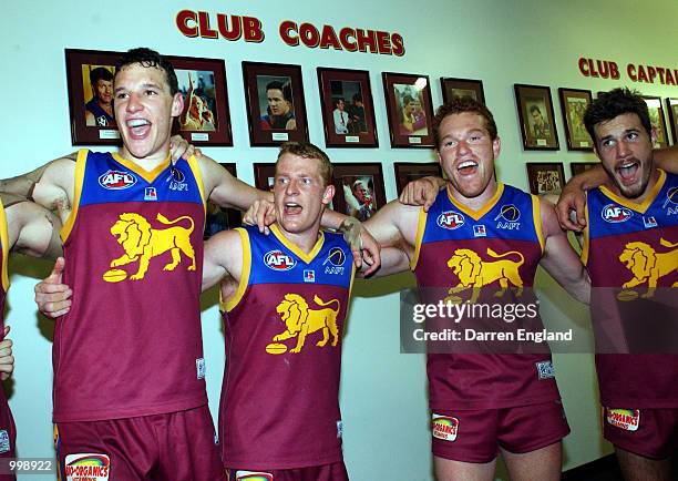 Beau McDonald, Michael Voss, Justin Leppitsch and Robert Copeland of Brisbane sing the team song to celebrate victory against Richmond during the AFL...