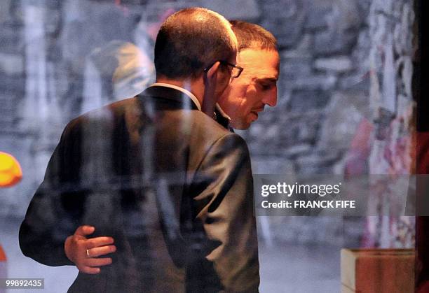 French forward Franck Ribery is seen through a window upon his arrival at France's national football team pre-World Cup training camp for the...