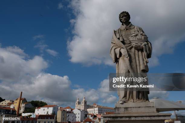 Statue of St Vincent of Saragossa or Sao Vicente de Fora, patron saint of the city, holding a boat with 2 ravens , at the lookout Miradouro Portas do...