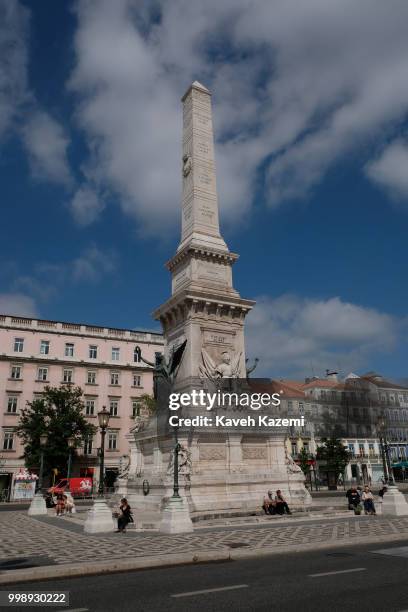 People sit around the monument in Central Square on June 11, 2018 in Lisbon, Portugal. "r"r