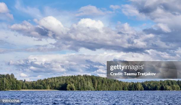 dramatic cumulus clouds in the bright summer day scene in finland - teemu tretjakov stock pictures, royalty-free photos & images