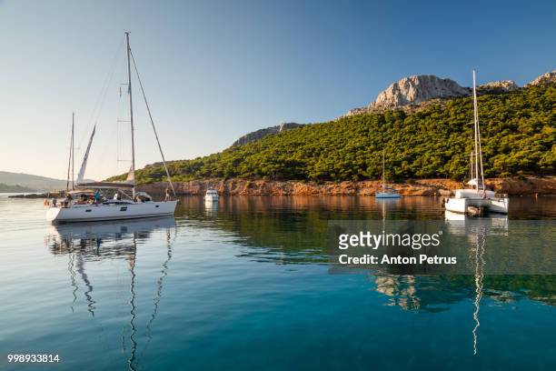 yachts near the uninhabited island. moni island, greece - anton petrus stock pictures, royalty-free photos & images