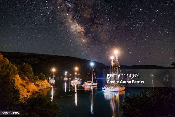 the milky way over the yachts. dokos island, greece - anton petrus stock pictures, royalty-free photos & images