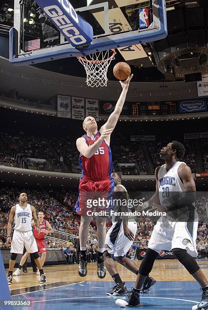 Chris Kaman of the Los Angeles Clippers makes a layup against Mickael Pietrus of the Orlando Magic during the game on March 9, 2010 at Amway Arena in...