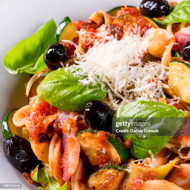 ribbon pasta with zucchini and olives in tomato sauce - tomato pasta stock pictures, royalty-free photos & images