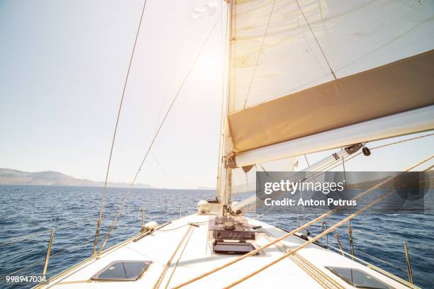 lonely yacht sailing on silent sea. aegina island, greece - schiffsbug stock-fotos und bilder