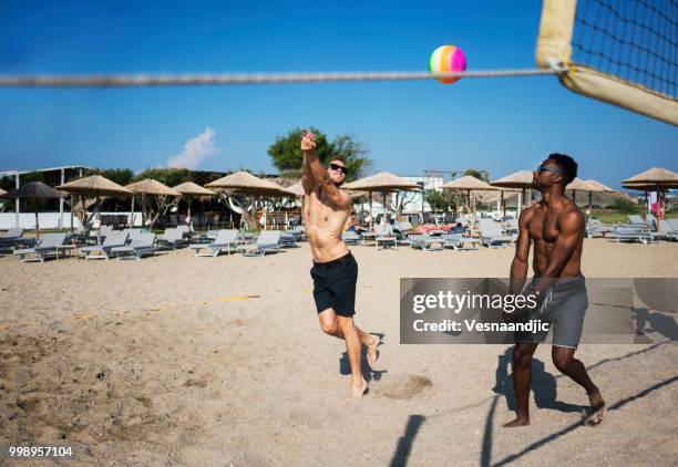 volleyball with friends at the beach - beach volleyball friends stock pictures, royalty-free photos & images