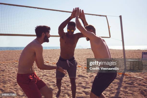 volleyball with friends at the beach - beach volleyball friends stock pictures, royalty-free photos & images