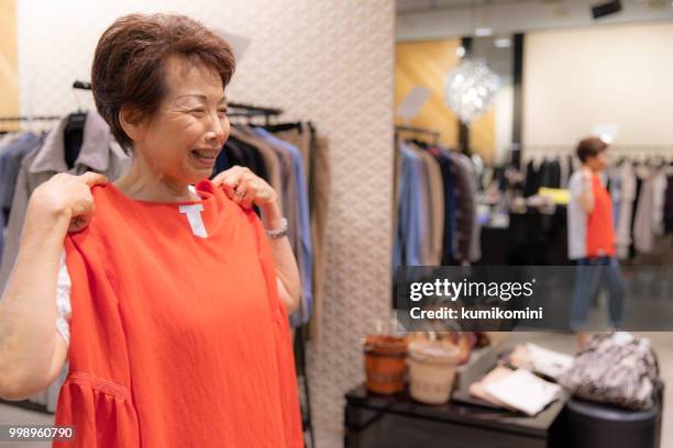 senior japanese woman shopping clothes - kumikomini stock pictures, royalty-free photos & images