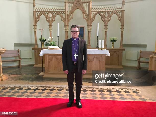 Dietrich Brauer , archbishop of the Evangelical Lutheran Church in Russia is standing in front of a banner of the 500th anniversary of the...