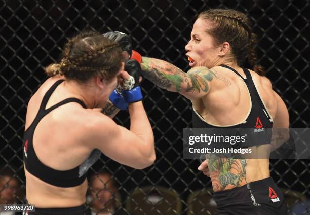 Liz Carmouche punches Jennifer Maia of Brazil in their women's flyweight fight during the UFC Fight Night event inside CenturyLink Arena on July 14,...