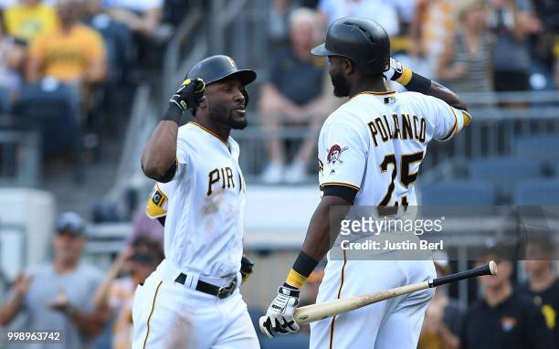 Starling Marte of the Pittsburgh Pirates celebrates with Gregory Polanco after hitting a solo home run in the eighth inning during the game against...