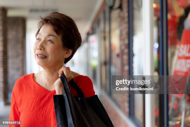 senior japanese woman shopping - kumikomini stock pictures, royalty-free photos & images