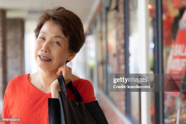 senior japanese woman shopping - kumikomini stock pictures, royalty-free photos & images