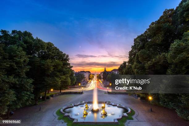 fountain at friedensengel, where is the famous landmark for sunset time with transportation on avenue in munich, germany, europe - terrasse stockfoto's en -beelden