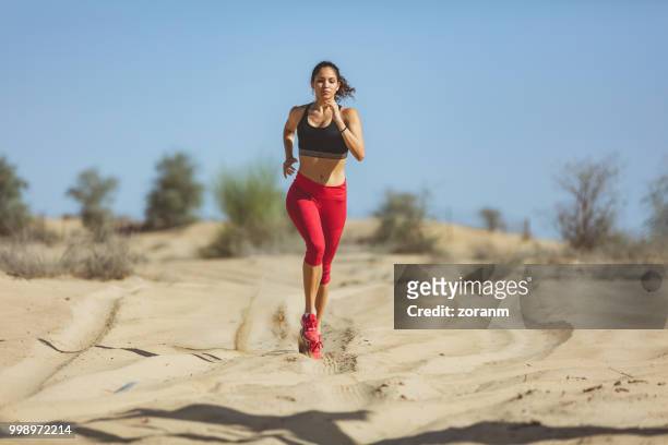 young runner navigating through the desert - zoranm imagens e fotografias de stock