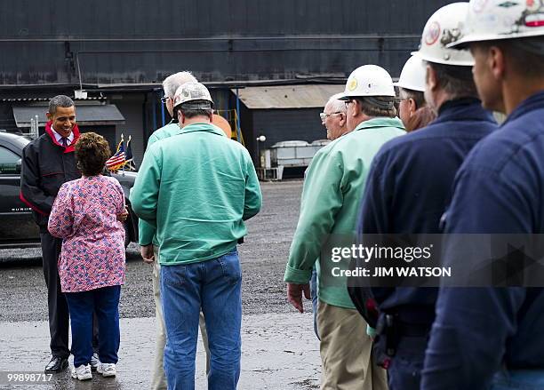 President Barack Obama speaks with Mary Ann Decapita from Human Resources, as he shakes hands with workers as he tours through V & M Star, a leading...