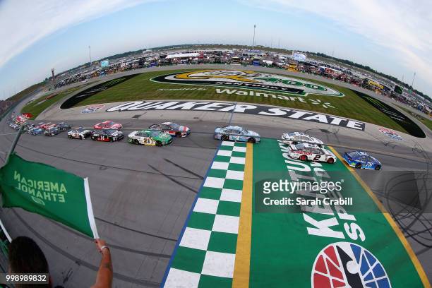 Martin Truex Jr., driver of the Auto-Owners Insurance Toyota, leads the field past the green flag to start the Monster Energy NASCAR Cup Series...