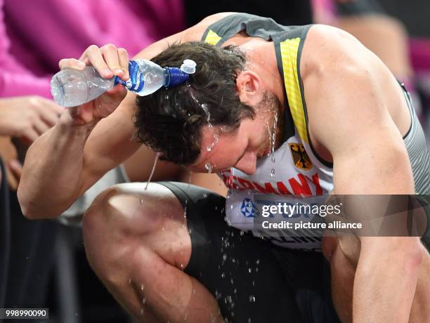 German athlete Kai Kazmirek pours water over his head after competing in the men's 400 metre decathlon event at the IAAF World Championships, in...