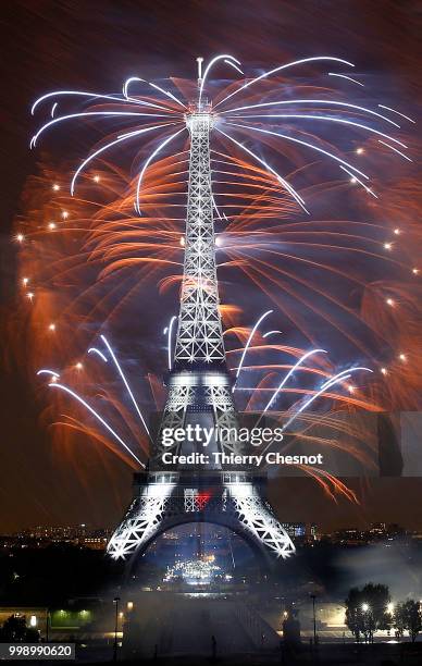 Fireworks burst around the Eiffel Tower as part of Bastille Day celebrations on July 14, 2018 in Paris, France. The theme of the fireworks of this...