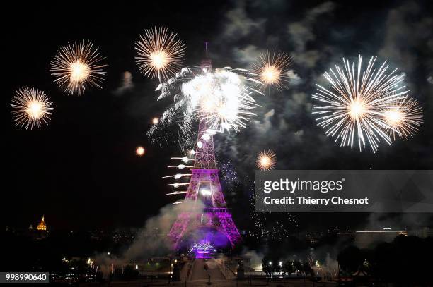 Fireworks burst around the Eiffel Tower as part of Bastille Day celebrations on July 14, 2018 in Paris, France. The theme of the fireworks of this...